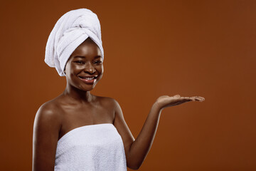 Beautiful Black Woman With Towel On Hand Holding Standing With Open Palm