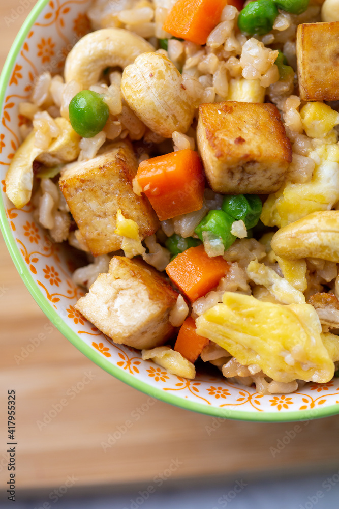 Wall mural close up top view of bowl of tofu cashew fried rice