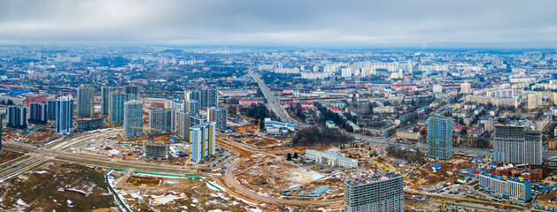 Construction of high-rise resedential buildings. The construction industry with working equipment. View from above. Eye bird view of new resedential district.