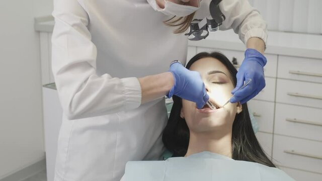 The doctor dentist woman doing an injection of anesthesia to a patient 4K