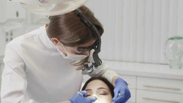 The doctor dentist woman doing an injection of anesthesia to a patient 4K