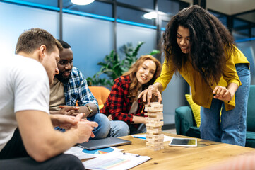 Happy friendly business people playing in office, taking a break. Joyful multiethnic coworkers having fun, resting from tense brainstorm, distracted from work or study