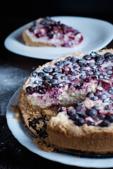 Berry pie cake from the cherries currants in a bowl of fresh steam a whole and slices of hot background blurred