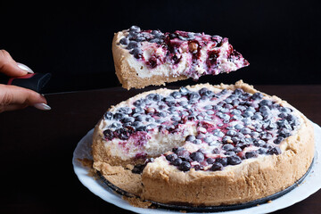 Berry pie cake from the cherries currants in a bowl of fresh, steaming hot cuts off a piece of the background is blurred