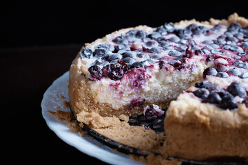 Berry pie cake from the cherries currants in a bowl of fresh steam a whole and slices of hot background blurred