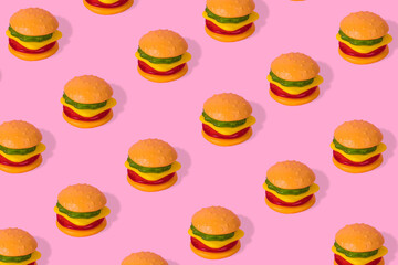 Creative trendy idea fast food pattern-  Hamburger on bright pink background
