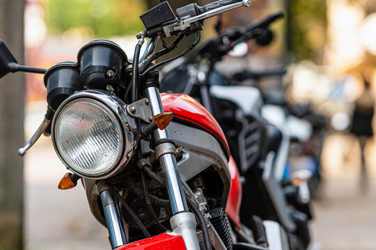 a row of motorcycles parked on the side of the street, close-up of details, selective focus