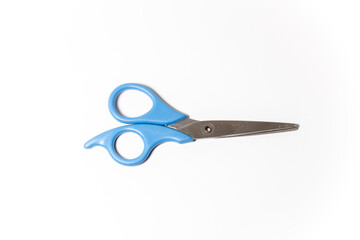 Blue metal scissors laying over a white background