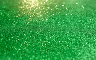 Abstract green blurred background with metallic glitter bokeh 