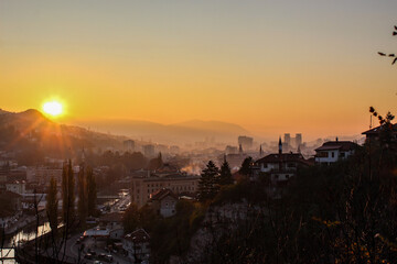 Fototapeta premium Beautiful sunset over Sarajevo and Sarajevo City Hall. Beautiful view of the city and the silhouettes of other sights of the city of Sarajevo.