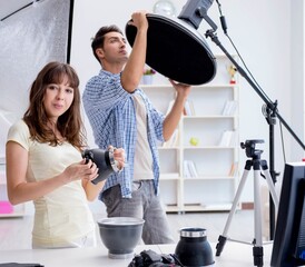 Young photographer working in photo studio