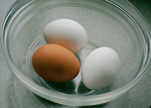 A Trio Of Eggs In A Clear Glass Bowl