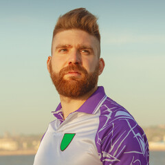 Close up portrait of handsome football player at morning training near seaside. Outdoor shot © Augustino