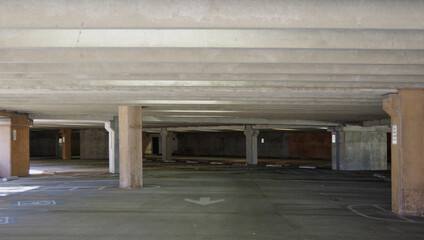 View of a totally empty level of a large parking garage concrete structure