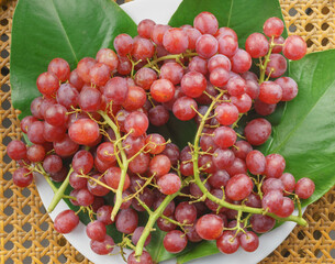 Top view of a bunch of grapes on the table. It is a vegetarian and vegan food concept