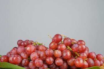 Side view of a bunch of grapes on the leaf. It is a vegetarian and vegan food concept