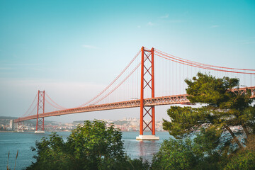 25 De April Bridge. Red bridge is connecting Lisbon and Almada across the river Tagus. Lisbon and Portugal sightseeing.