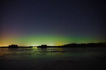 Northern Lights over the frozen lake in Littoinen, Finland.