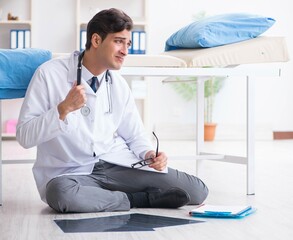 Doctor sitting on the floor in hospital