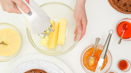 Woman hands mixing butter for cake using an electric mixer. Step by step chocolate cake recipe....
