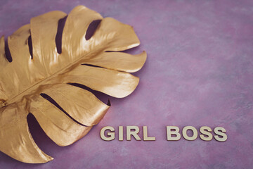 equal opportunities Girl Boss text on top of golden leaf symbol of wealth and luxury