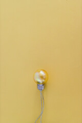 colorful yellow light bulb symbol of creativity and ideas on tone on tone background with copyspace to add your text