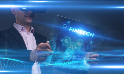 Business, Technology, Internet and network concept. Young businessman working on a virtual screen of the future and sees the inscription: Fintech
