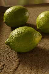 Green lemon on the sand