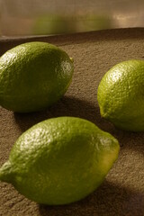 Green lemon on the sand