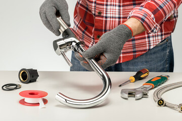 Plumber at work in a kitchen or bathroom, repair service, assemble and install concept.