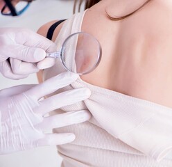 Doctor examining the skin of female patient