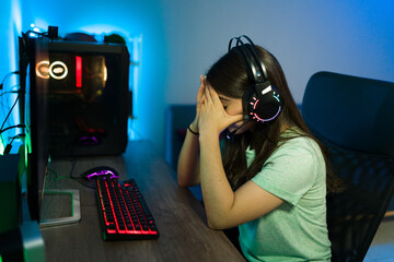 Sad woman gamer losing an online game match © AntonioDiaz