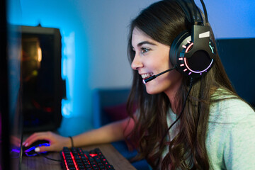 Excited woman finishing an online videogame in a gaming PC © AntonioDiaz