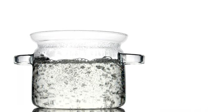 Cooking pot with boiling water on white background
