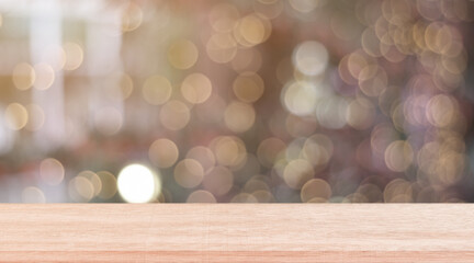 Wooden shelf over blur bokeh light background. Empty wood table top, counter for display product for promotion.