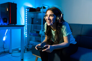 Woman gamer smiling while talking to an online player