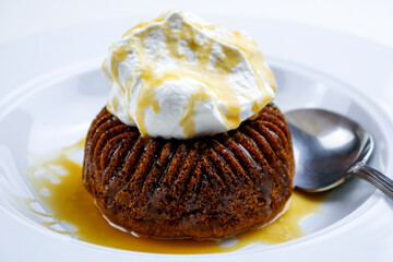 Sticky Date Pudding with Salted Rum Caramel Sauce, Topped with Fresh Whipped Cream