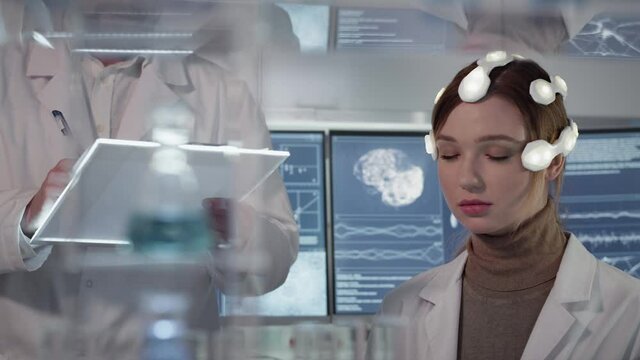 Working on brainwave scanning headset. Woman wearing sensors