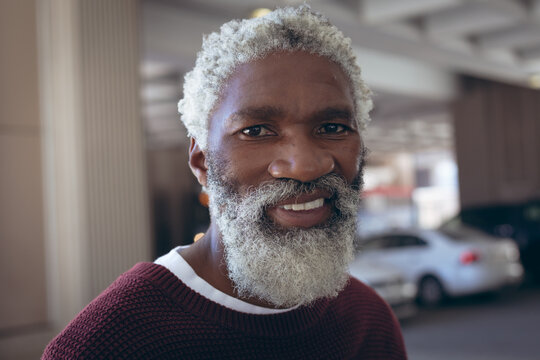 Portrait Of Casually Dressed African American Senior Man With Beard Smiling In Street