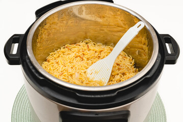 Pasta cooked in Instant Pot. Delicious orzo pasta close up in a pot on white background with copy space