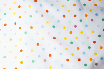 Fabric background with pattern. Rainbow balls on the fabric.