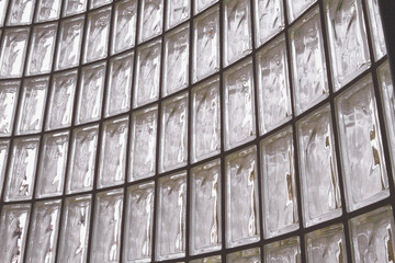 Curved wall of glass blocks; abstract design of light through glass block window