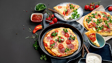 Delicious fresh pizzas variety with different souces and vegetables. Homemade food concept.