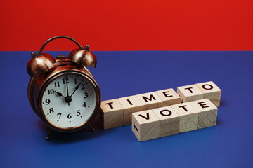 Time to Vote alphabet letter with alarm clock on blue and red background