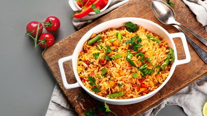 Vegan fried rice with pepper, carrot and green beans and greens