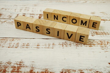 Passive Income Word alphabet letters on wooden background