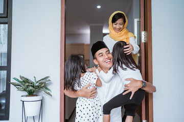 portrait of excited father hug and embrace his children during eid mubarak celebration together