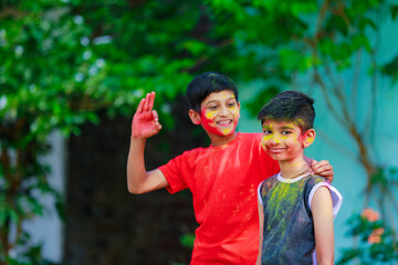 Obraz premium Cute indian little child’s group playing holi. Holi is colors festival in india