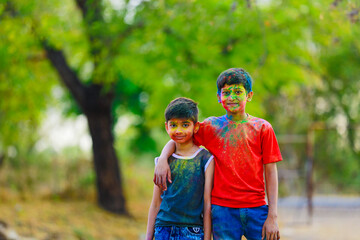 Cute indian little child playing holi. Holi is colors festival in india