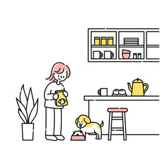 キッチンで犬にごはんをあげる女性